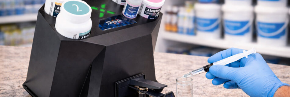 Taylor Xpress Flex pool water testing system analyzing a customer water sample on a countertop inside a pool supply store.