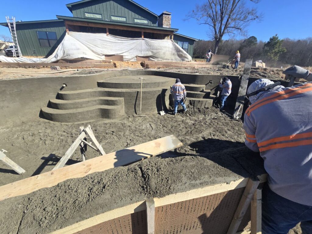 custom swimming pool construction with concrete shell and spa being formed in East Texas